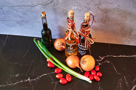 Berlin, Germany - March 5, 2021: Various oils such as date balsamic and orange oil with fresh ingredients.のeditorial素材