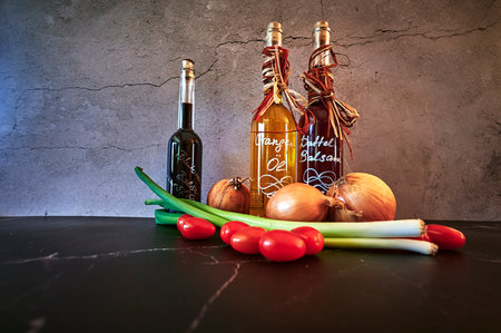 Berlin, Germany - March 5, 2021: Various oils such as date balsamic and orange oil with fresh ingredients.のeditorial素材