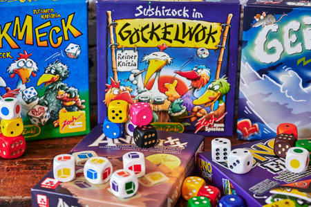 Berlin, Germany - March 22, 2021: Many different packs of board games and dices as activity against...