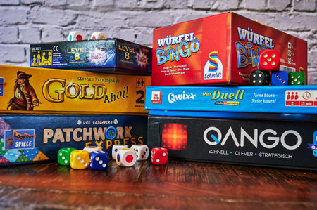 Berlin, Germany - March 22, 2021: Many different packs of board games and dices as activity against...