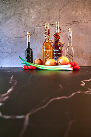 Berlin, Germany - March 5, 2021: Various oils such as date balsamic and orange oil with fresh ingredients.のeditorial素材