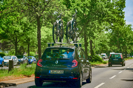 Berlin, Germany - July 3, 2021: Car with a bike carrier attached on the top and two bicycles mounted on it.のeditorial素材