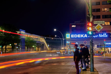 Berlin; Germany - June 23; 2021: Night shot of a busy intersection in downtown Berlin with ghost effects due to the long exposure time.のeditorial素材
