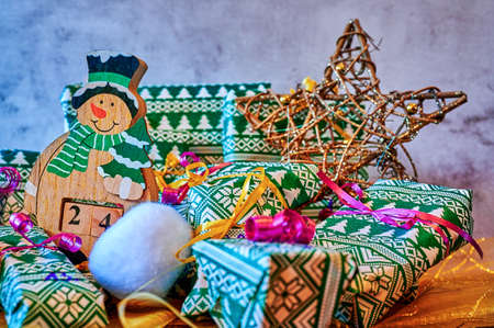 Wrapped gifts that are part of an advent calendar and Christmas decorations.
