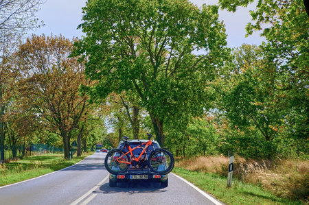 Brandenburg, Germany - September 15, 2019: Car with a bike carrier attached to the stern and bicycles mounted on it.のeditorial素材