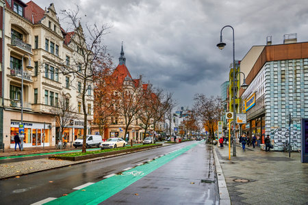 Berlin, Germany - November 23, 2021: Street scene with a green painted cycleway in a business street in Berlin-Steglitz.のeditorial素材