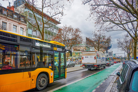 Berlin, Germany - November 23, 2021: Street scene with a green painted cycleway in a business street...