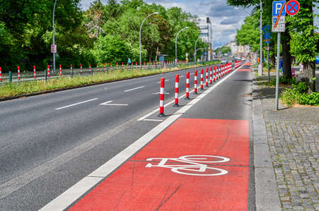 Separated bike lane on a main street in Berlin to improve road safety at the expense of parking lane.の写真素材