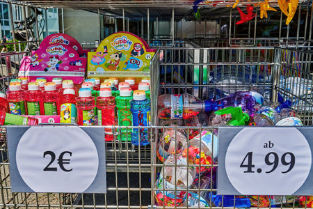 Berlin, Germany - June 22, 2022: Sales stand with various colorful containers for soap bubbles and other summer toys.のeditorial素材