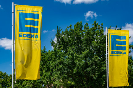 Berlin, Germany - July 2, 2022: Flags of the supermarket Edeka for food, beverage and household items in Berlin, Germany.のeditorial素材