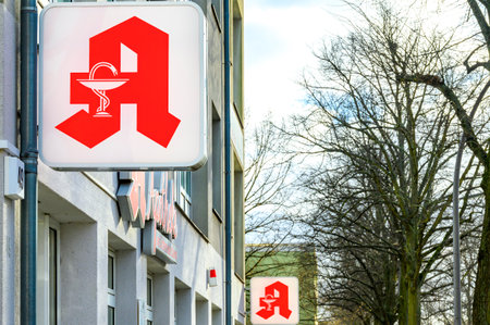 Berlin, Germany - January 28, 2022: View along a facade with the sign of a pharmacy in the foreground.のeditorial素材