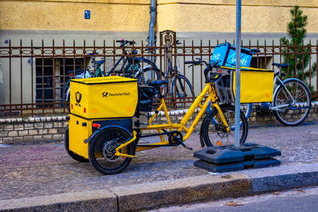 Berlin, Germany - February 9, 2023: Electric tricycle from the company Deutsche Post on a sidewalk in Berlin.のeditorial素材