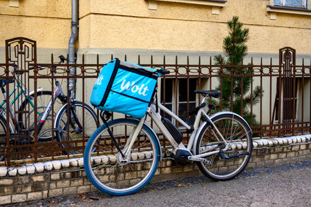 Berlin, Germany - February 9, 2023: Bike of a food delivery service parked on a sidewalk.のeditorial素材