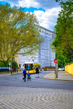 Berlin, Germany - April 26, 2020: Tram in the center of Berlin near the Berlin Museum Island with people in the foreground.のeditorial素材