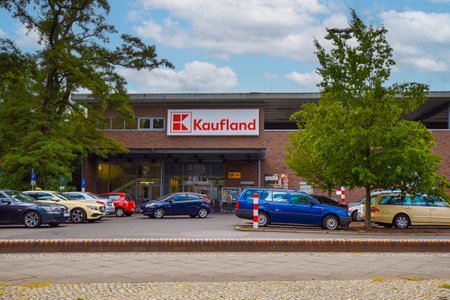 Berlin, Germany - July 6, 2018: Supermarket in Berlin, Germany, with a parking lot in the foreground.のeditorial素材