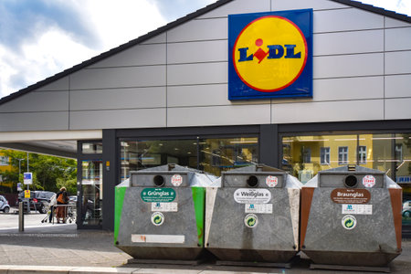 Berlin, Germany - July 6, 2018: Supermarket in Berlin, Germany, with recycling containers for glass waste in the foreground.のeditorial素材