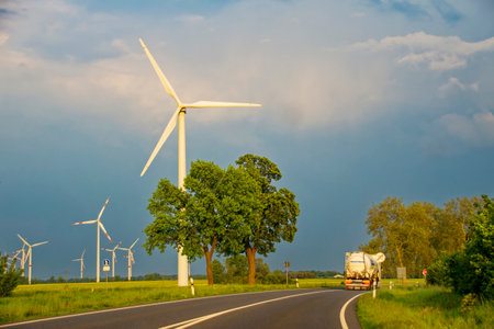 Lower Saxony, Germany - May 24, 2019: Wind farm with many wind turbines beside a country road.