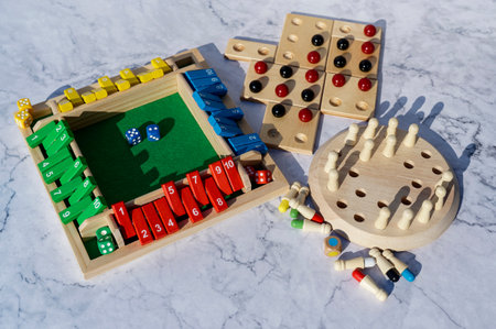 Different wooden board games with gaming accessories.