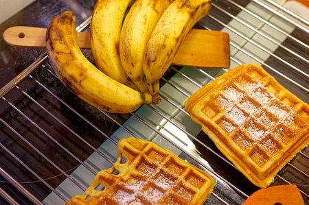 Ready-made waffles that lie on a grating to cool and bananas as an ingredient.の写真素材