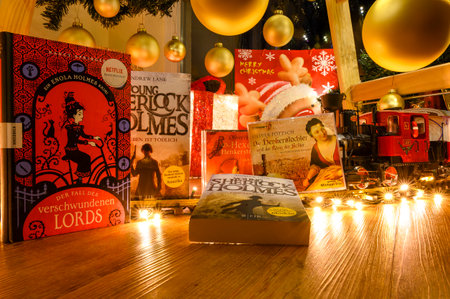 Berlin, Germany - December 25, 2022: Different books and audiobooks amid twinkling lights and Christmas decorations.のeditorial素材