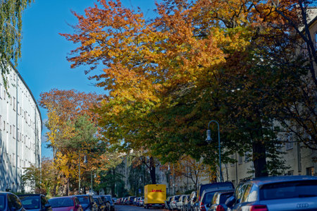 Berlin, Germany - November 4, 2023: Autumnal street scene in Berlin with a parked parcel service van.のeditorial素材