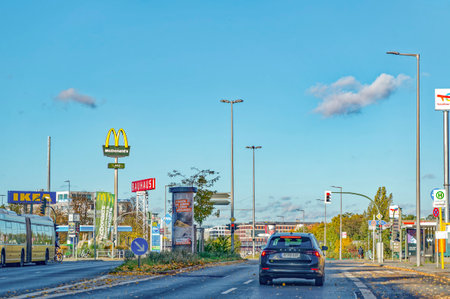 Berlin, Germany - November 04, 2023: Autumnal street scene in Berlin with various advertising signs.のeditorial素材