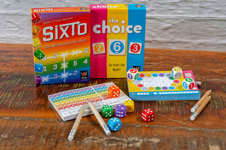 Berlin, Germany - January 16, 2024: Various packs of parlor games with gaming accessories.のeditorial素材