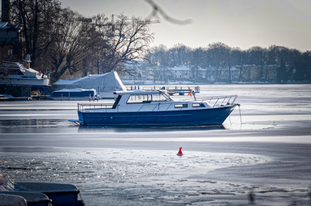 Winter scene with a lonely vessel on the frozen Dahme river in Berlin Koepenick.の写真素材