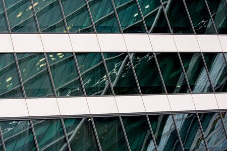Fragment of modern building. Close-up. A beautiful combination of metal and glass. Effective...