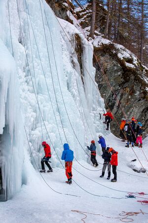 France, Bessans - January 27, 2019: Training athletes at the winter ice climbing wall.のeditorial素材