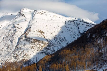 Two slopes in the Alpine mountains in winter: wooded and rocky. France, Savoyの写真素材