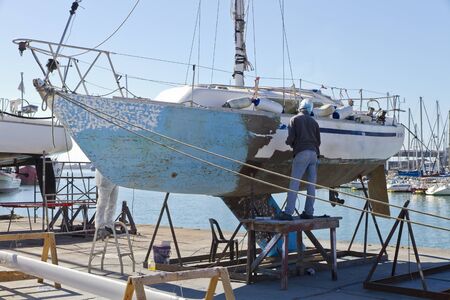 Yacht maintenance at the harbor. Preparation for painting.の写真素材