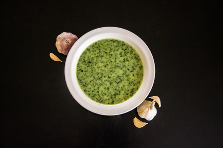 Spinach soup with garlic on dark tableの写真素材