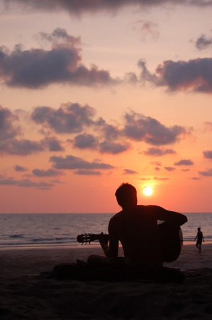 Man playing guitar on the beachの写真素材