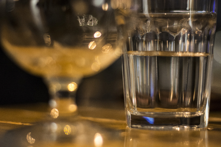 Glass of water on wooden table at Christmas Eveの写真素材