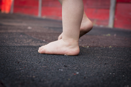 Child's feet on the  floor. Concept Baby first step.の写真素材