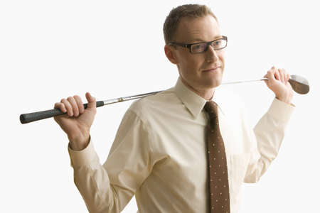 A businessman is holding a golf club around the back of his neck.  Horizontal shot.  Isolated on white.の写真素材