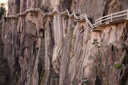 A plank road built along the face of a cliff in Huangshan Chinaの写真素材