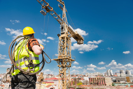 Construction worker under the tower craneの写真素材