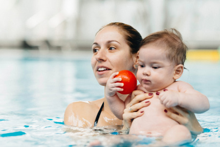 Mother and baby in swimming poolの写真素材