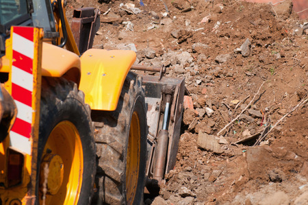 Front end loader clearing dirt on the construction site. Selective focusの写真素材