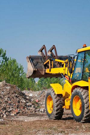 Front end loader working in the rubble pileの写真素材