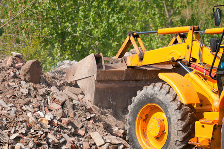Loader clearing piles of rubbleの写真素材