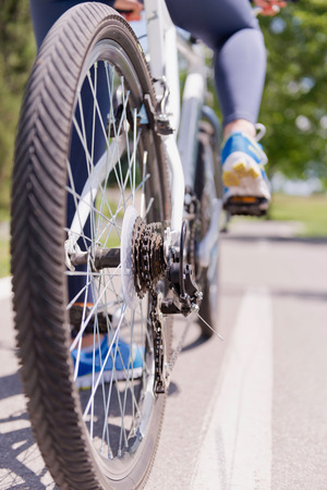 Bicycle on the road, rear view, chain and gears in focusの写真素材