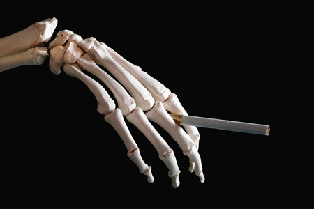 Skeleton hand holding cigaretteの写真素材