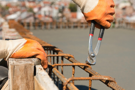 Binding armature with pliers at construction siteの写真素材