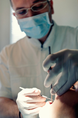 Dentist working with patientの写真素材