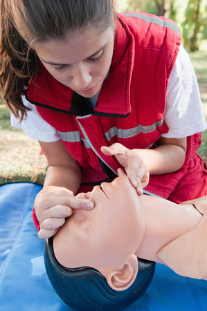 Paramedic preparing to ventilate victim during CPR training with a dummy. Model is member of actual European first aid champions team for 2011/2012.の写真素材