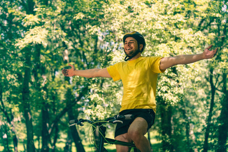 Young man enjoying bicycle ride in natureの写真素材