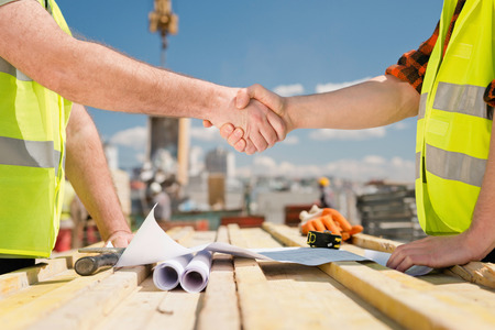 Hanshake seals an agreement at construction siteの写真素材